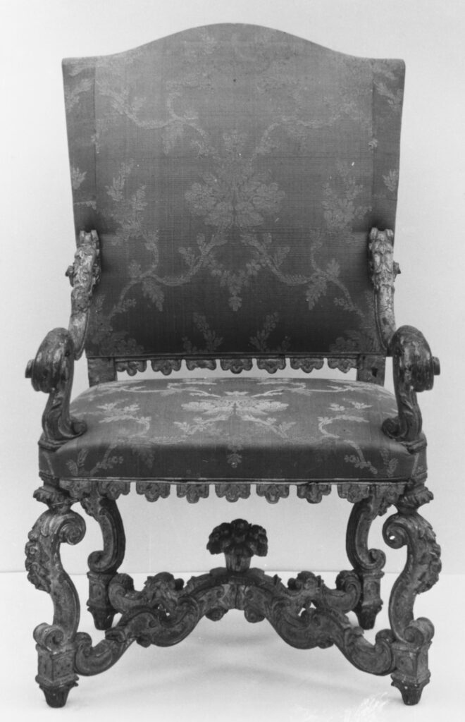 an elaborate armchair, one of a pair